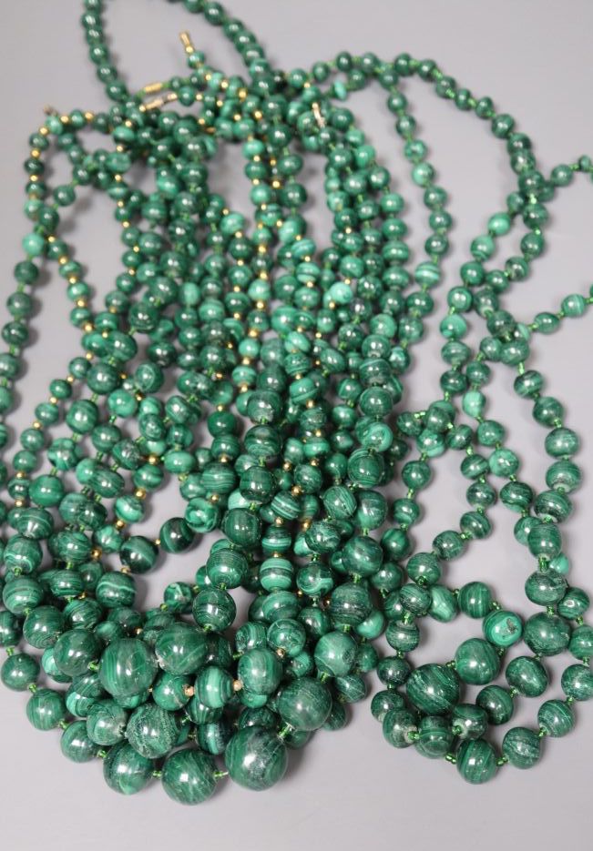 Ten assorted single strand malachite bead necklaces, two with gilt metal spacers, largest 64cm.